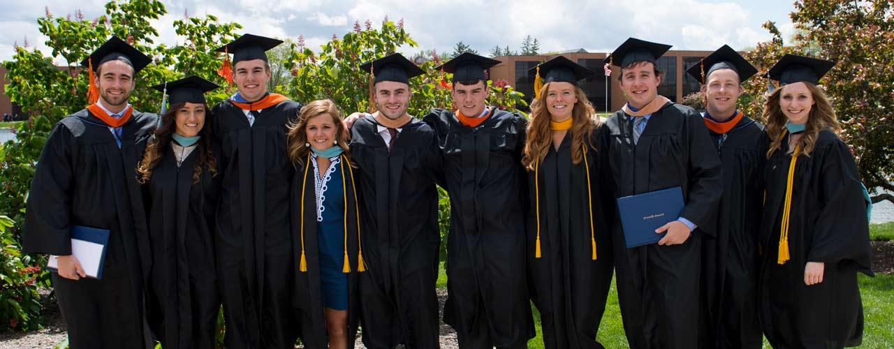 Group of Cedarville graduates smile by the lake